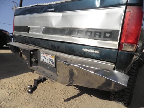1994 Ford F-250 - Rear view of a 1994 Ford F-250 pickup truck with a dented bumper and tailgate.