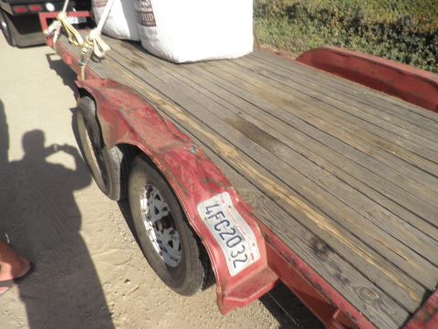 1994 Ford F-250 - Trailer loaded with seed bags, showing its wooden deck and red fender. License plate is visible.