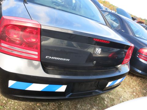 1991 Ford LTD Crown Victoria - The rear of a Dodge Charger is shown, with blue and white reflective tape on the bumper.