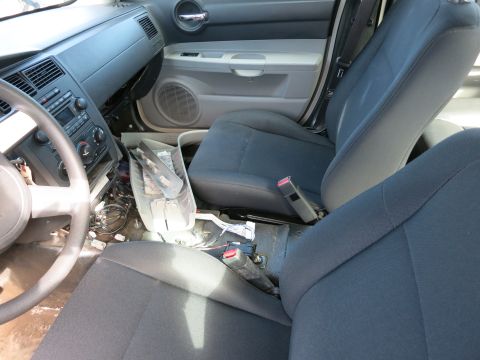 1991 Ford LTD Crown Victoria - Interior view of a car's front seats and dashboard, with the center console disassembled.