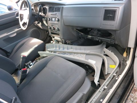 1991 Ford LTD Crown Victoria - The interior of a Dodge vehicle shows a disassembled dashboard and seats, indicating it is likely being repaired or stripped for parts.