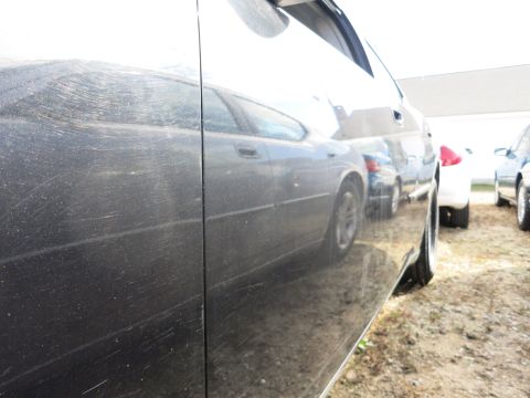 1991 Ford LTD Crown Victoria - The reflection shows a sedan with a body style consistent with a 1991 model, but the claim is incorrect.