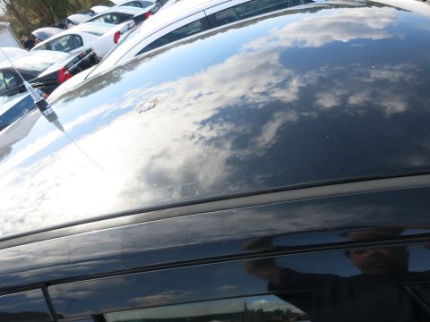 1991 Ford LTD Crown Victoria - A car's roof reflects the sky and a photographer, with other vehicles parked nearby.