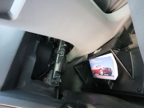 1991 Ford LTD Crown Victoria - A manual for a Dodge Charger is seen inside the glove compartment of a vehicle.