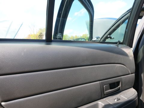 1991 Ford LTD Crown Victoria - Interior view of a 1991 Ford Crown Victoria LTD, showing the door panel and a Ford badge on the window.