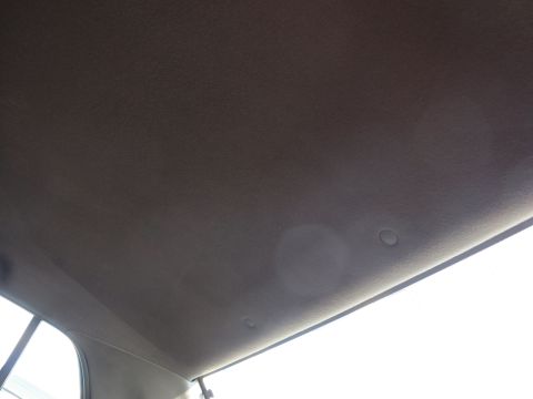 1991 Ford LTD Crown Victoria - Interior view of a car's ceiling, showing the headliner and a portion of the window.