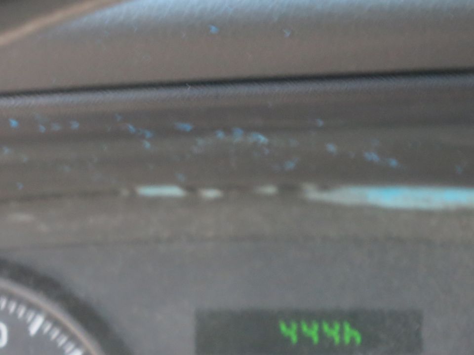 Dashboard interior with a partial speedometer and a digital display showing '444h'