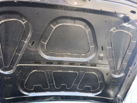 1991 Ford LTD Crown Victoria - The interior structure of a vehicle's hood is visible, showing its construction and insulation.
