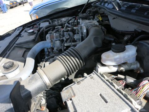 1991 Ford LTD Crown Victoria - The engine bay of a vehicle is shown with various components and wiring.