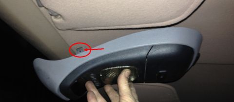 1993 Ford Bronco - Close-up of a vehicle's overhead console, highlighting a clip with a red arrow.