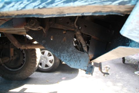 1994 Ford F-250 - Undercarriage detail with hitch receiver and suspension parts visible.