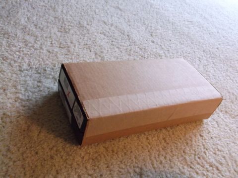 2011 Harley-Davidson Elec Gld Police - A cardboard box sits on a carpeted surface. Some text is visible on the side of the box.