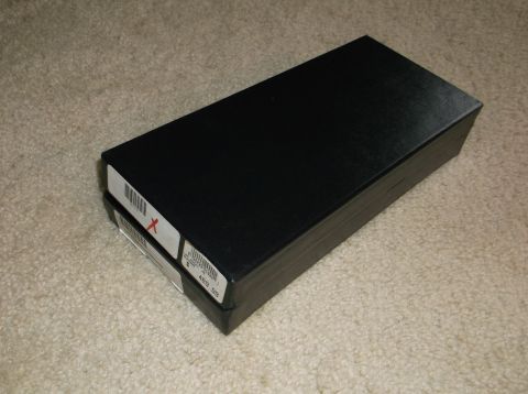 2011 Harley-Davidson Elec Gld Police - A close-up view of two black boxes resting on a textured carpet. One box has a label with a red X.