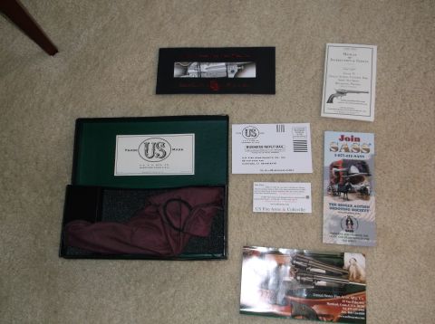 2011 Harley-Davidson Elec Gld Police - Various documents and accessories related to US Fire Arms & Coltville are displayed on a carpeted surface.