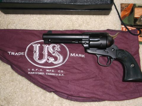 2011 Harley-Davidson Elec Gld Police - A black revolver rests on a cloth with USFA Mfg. Co. Hartford, Conn. U.S.A. text.