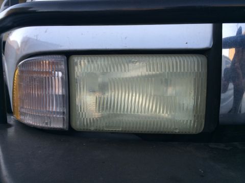 1997 Dodge 3500 - Close-up of the driver's side headlight and amber turn signal assembly on a Dodge truck.