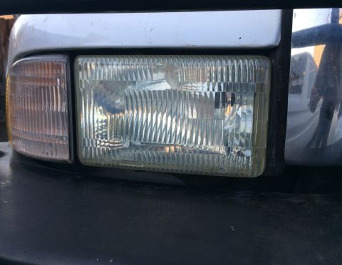 1997 Dodge 3500 - Close-up of the headlight and amber turn signal assembly on a 1997 Dodge 3500 truck.