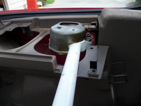 1993 Mazda MX-3 - Close-up of an interior car part, possibly a strut tower brace, with visible mounting hardware.