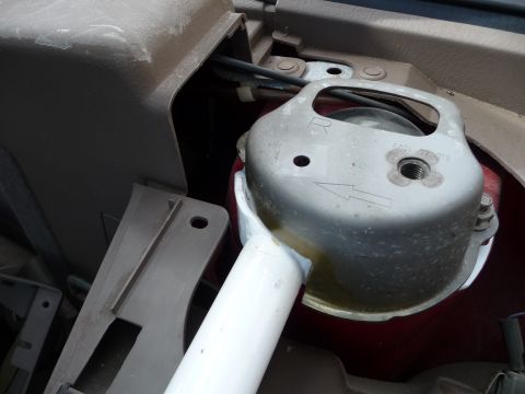 1993 Mazda MX-3 - A close-up view of a car's engine mount, revealing internal mechanical parts.