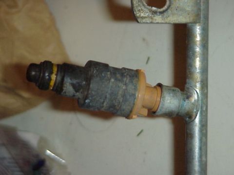 1989 Ford Bronco - A close-up view of a single fuel injector, likely a replacement part.