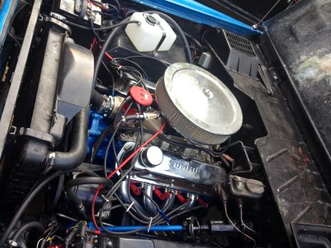1974 Ford Bronco - Close-up view of a modified engine bay, showing various components and wiring.