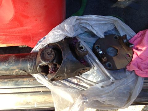 1987 Suzuki Samurai - A damaged driveshaft and flange are shown, likely removed from a vehicle for repair.