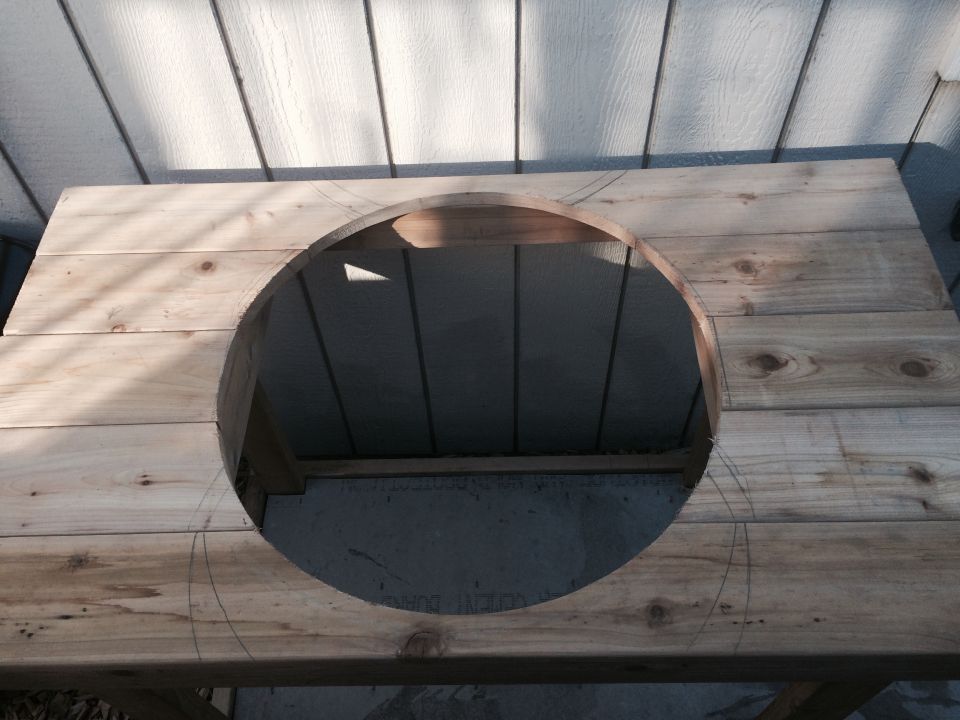 Wooden table with a large circular cutout, marked with pencil lines