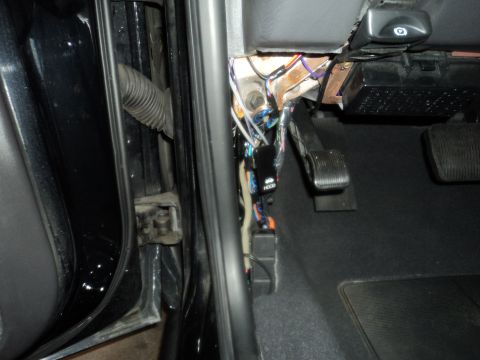 2004 Mercury Grand Marquis - Exposed wiring and pedals are visible inside the car's interior.