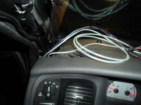 2004 Mercury Grand Marquis - Wiring is visible above the dashboard of a car, near the headlight controls and instrument cluster.