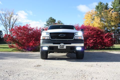 2006 Chevrolet Silverado 2500 - White 2006 Chevrolet Silverado 2500 pickup truck with a CAT plate, parked outdoors.