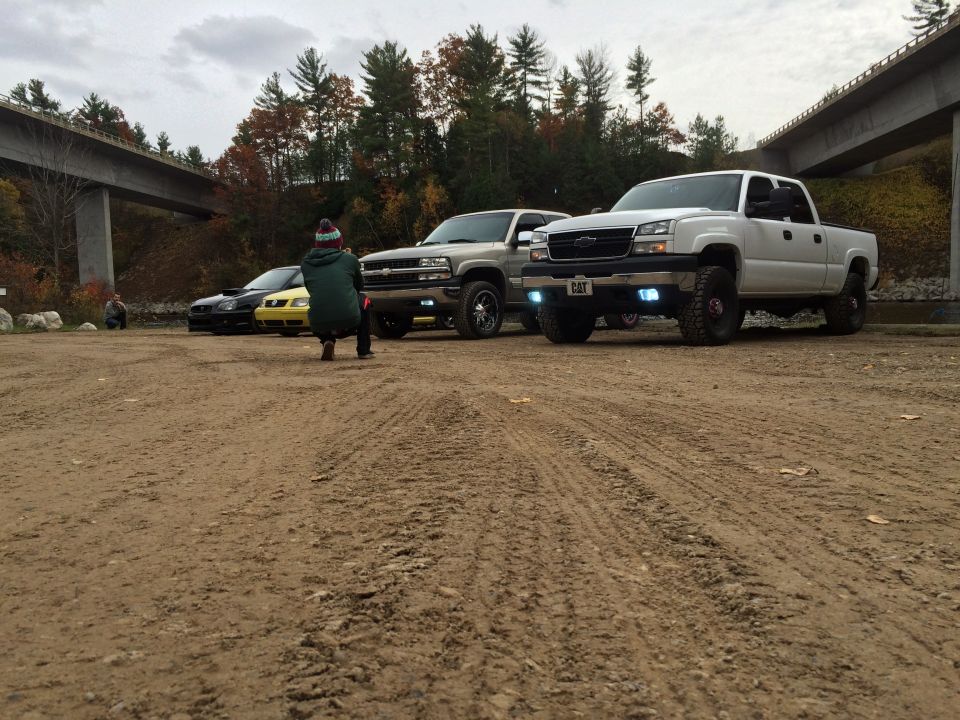 White 2006 Chevrolet Silverado 2500 front 3/4 view with aftermarket grille and fog lights