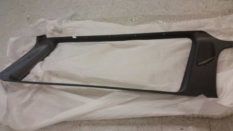 1987 Dodge 1500 - A black plastic automotive interior trim piece is shown, likely a pillar cover, resting on white packaging material.