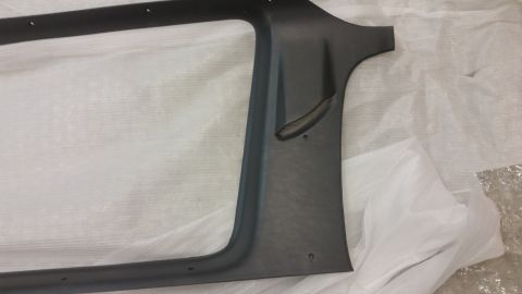 1987 Dodge 1500 - A dark gray plastic interior trim piece is shown from an angle, resting on white protective wrapping.