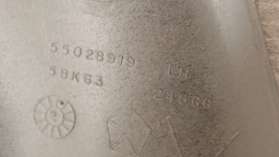 Part with embossed numbers 55028919, 5BK63, LH, 24566, and a Chrysler pentastar symbol