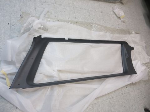 1987 Dodge 1500 - A dark gray plastic trim piece, likely for a vehicle's interior pillar, is shown laid out on protective wrapping.