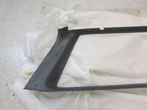 1987 Dodge 1500 - A dark gray plastic trim piece is shown, likely a component for a vehicle's window or bodywork.
