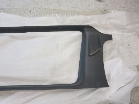 1987 Dodge 1500 - A dark gray plastic trim piece, likely an interior component, is shown laid out on white protective material.