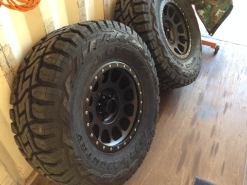 1996 Ford Bronco - Off-road tires and wheels are shown, with text visible on the tire sidewalls.