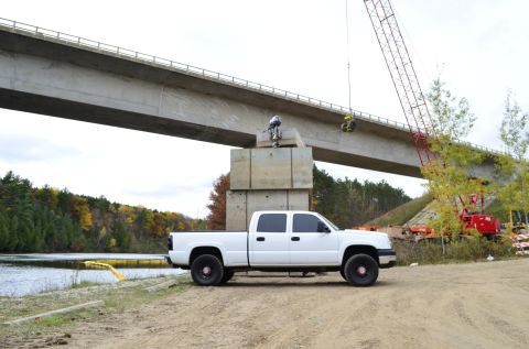 2006 Chevrolet Silverado 2500 - White 2006 Chevrolet Silverado 2500 parked near a river during bridge construction.