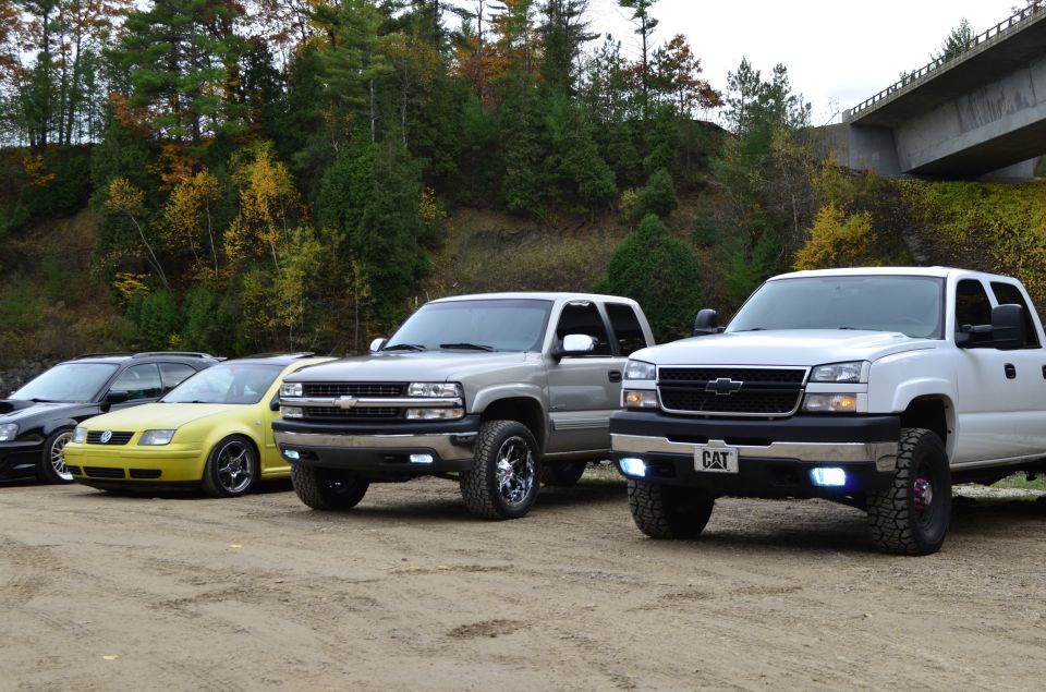 Silver Chevrolet Silverado 2500 front view with chrome grille and aftermarket wheels