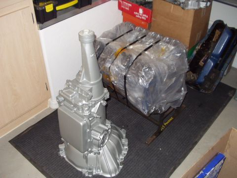 1967 Ford Mustang - Automatic transmission and engine block components are shown in a garage setting.