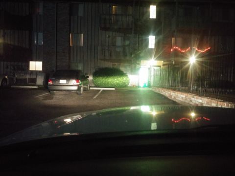 2000 Mercury Grand Marquis - A silver sedan is parked in a lot at night, with its rear facing the camera.