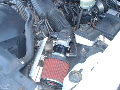 1998 Ford Crown Victoria - engine bay fitted with an aftermarket open-element red cone air filter on a polished intake tube.