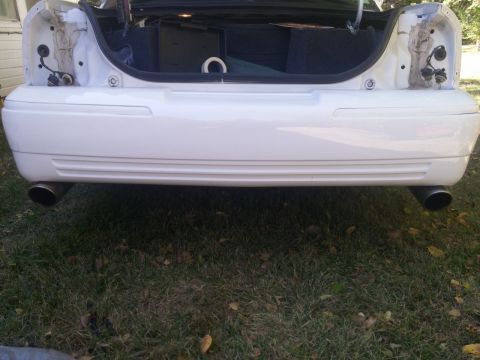 2000 Mercury Grand Marquis - Rear view of a white 2000 Mercury Grand Marquis, showing the bumper and exhaust system.