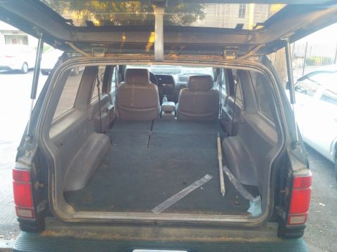 2000 Mercury Grand Marquis - View of the cargo area and front seats of an SUV, with the rear hatch open.