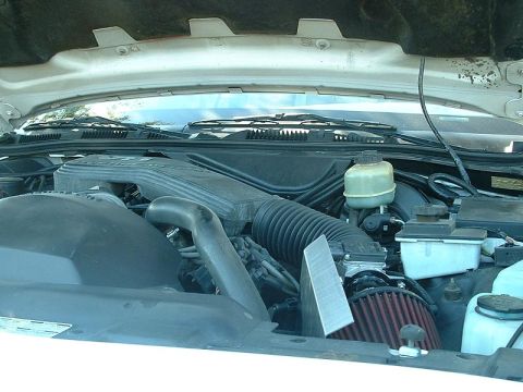 1998 Ford Crown Victoria - Engine bay showing an aftermarket red cone air filter, ducting, and the brake fluid reservoir.