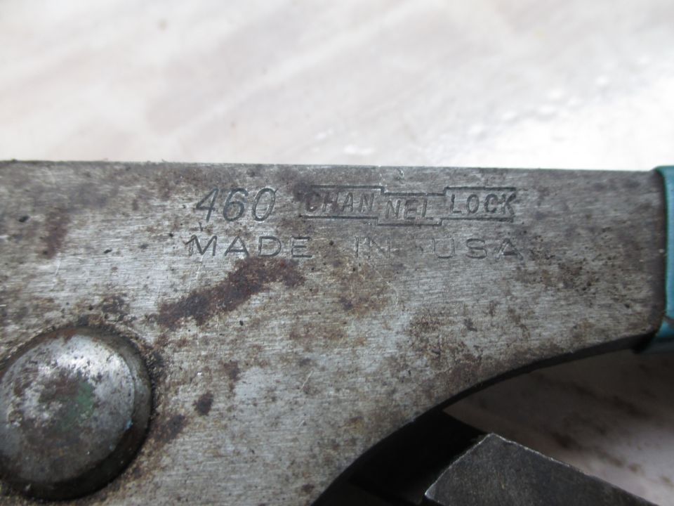 Close-up of worn metal Channel Lock pliers with model number 460 and "MADE IN USA" stamped on the side