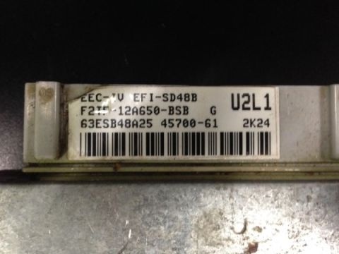 1993 Ford Bronco - Engine control module with visible part numbers and barcode.
