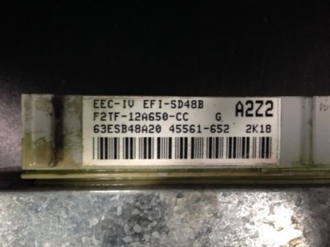 1993 Ford Bronco - This is a close-up view of a vehicle's electronic control module, showing its part number and barcode.