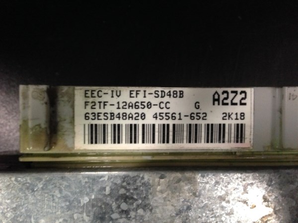 Close-up of an EEC-IV EFI-SD48B computer module with part number F2TF-12A650-CC and barcode